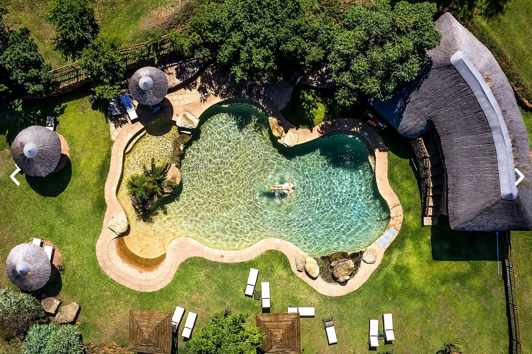 Luxury Drakensberg lodge swimming pool overlooking the African bush, perfect for relaxing between game drives.